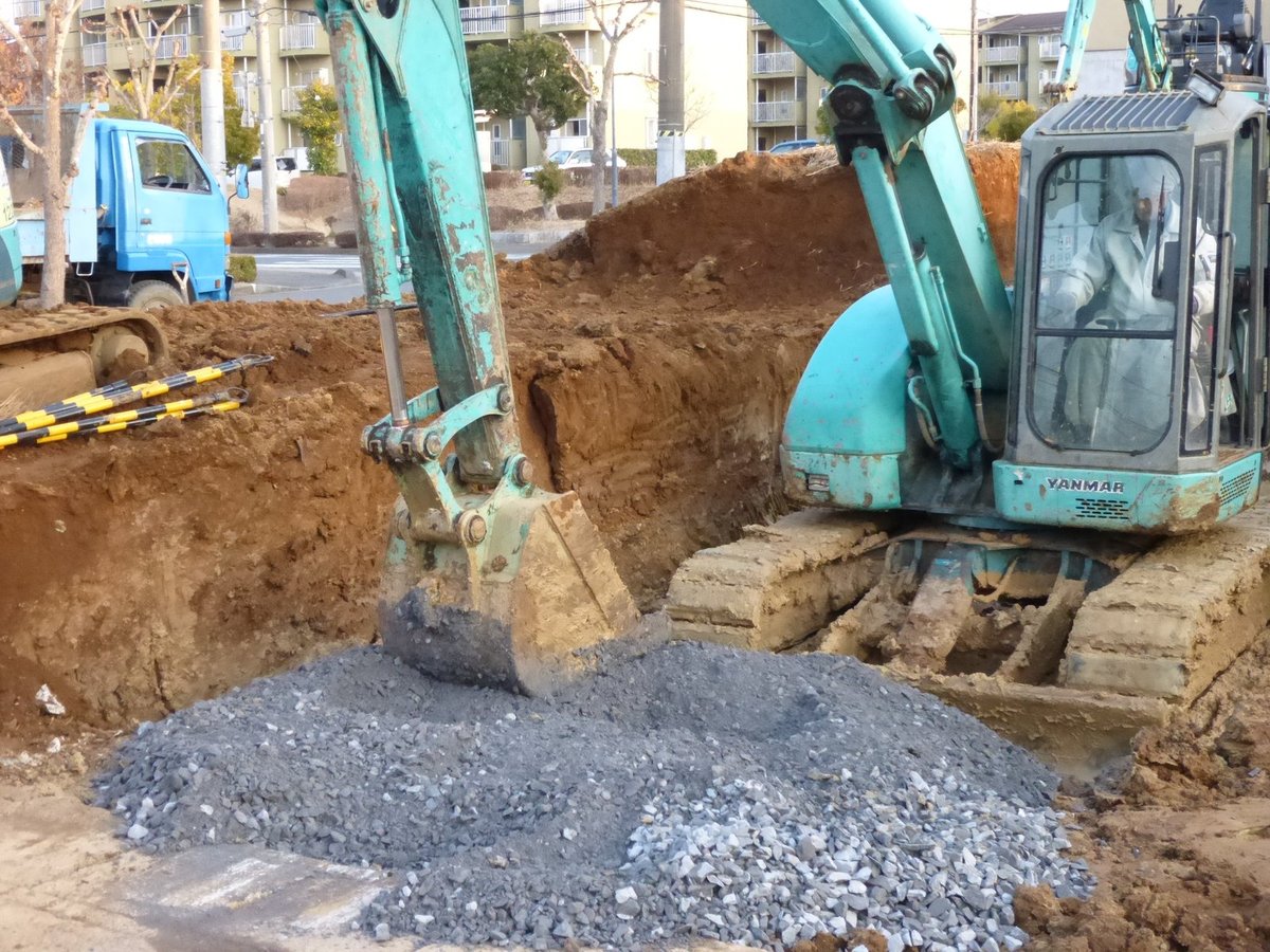 牛久市 重機で地面を掘り砕石を入れる工事